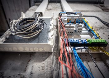 Voltage switchboard with circuit breakers are in the ON and OF positions in the big electric box for electrical distribution panel, and temporary electric cables are switched.